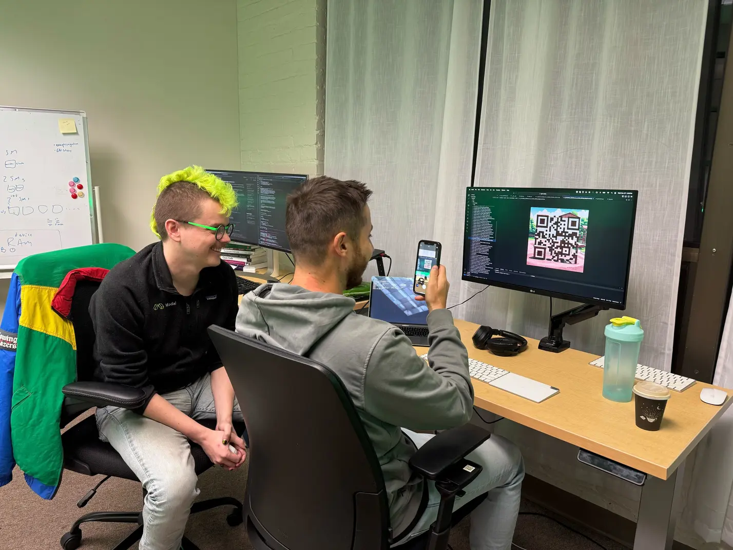 Two of the authors manually check whether a QArt code scans.